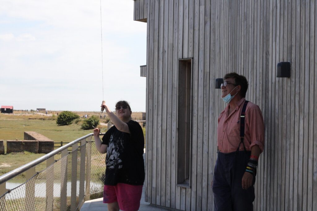 Charlie Stephens and Peter Quinell fly a kite at Rye Harbour.