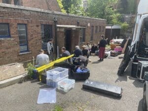 The film crew from The Stimming Pool sits outside Trinity Hall.