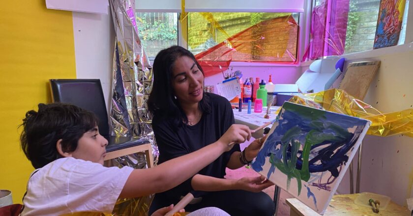 Nasreem and Yaya play together in the Art Breaks studio. Surrounded by coloured paper, different materials and paints.